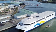 This handout photo taken and released on May 2, 2025 by Incat Tasmania shows an aerial view of the launch of the Hull 096 aluminium catamaran, the world's largest battery-electric ship, at the Incat shipyard in Hobart in Australia's island state of Tasmania. Photo by Handout / Incat Tasmania / AFP