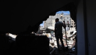 A Palestinian inspects the damage following overnight Israeli strikes, at the Nuseirat refugee camp in the central Gaza Strip on May 4, 2025.  (Photo by Eyad Baba / AFP)