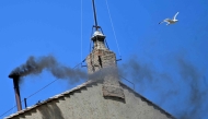 This photograph shows black smoke rising from the chimney of the Sistine Chapel signalling that cardinals failed to elect a new pope during their conclave in the Vatican on May 8, 2025. (Photo by Alberto PIZZOLI / AFP)