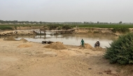 A general view of a small bridge used by farmers to cross the Sokoto river, localy called Maten Fada, in Argungu, Kebbi State, northern Nigeria on April 12, 2025. (Photo by Leslie Fauvel / AFP)