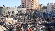 Palestinians sift through destroyed shelters at a UNRWA school housing displaced people, following an Israeli strike in the Bureij refugee camp in the centre of the Gaza Strip, on May 7, 2025. Photo by Eyad BABA / AFP