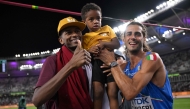 A file photo of Gianmarco Tamberi (right) and Mutaz Barshim and his son. 