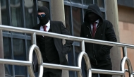  Daniel Graham (L), and Adam Carruthers, wearing face-coverings, arrive at Newcastle Magistrates' Court in Newcastle-Upon-Tyne, north east England on May 15, 2024, where they face two counts of criminal damage following the felling of the Sycamore Gap tree, in September 2023. Photo by Paul ELLIS / AFP