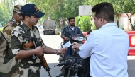 Indian Central Industrial Security Forces (CISF) personnel check identity card of Airport staff at the entrance road of the Shri Guru Ram Das Ji International Airport on the outskirts of Amritsar on May 12, 2025. (Photo by Narinder NANU / AFP)