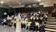 An expert from the Ministry of Awqaf and Islamic Affairs delivering a lecture at a school. 