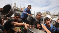 Palestinians struggle to get their food rations ouside a crowded distribution centre in Beit Lahia in the northern Gaza Strip on May 15, 2025. Photo by BASHAR TALEB / AFP.