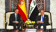 Iraq's Foreign Minister Fuad Hussein (R) meets with Spanish Prime Minister Pedro Sanchez ahead of the 34th Arab League summit in Baghdad on May 16, 2025. (Photo by Murtada Al-Sudani / Pool / AFP)