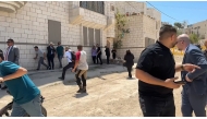 This frame grab from AFPTV footage shows members of a diplomatic delegation from the European Union reacting after shots were fired as they gathered in the eastern entrance of Jenin camp during a visit to the city of Jenin, on May 21, 2025, amid an ongoing Israeli military offensive in the occupied West Bank. Photo by Mohammad Ateeq / AFPTV / AFP.