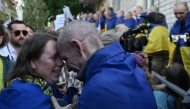 Ukrainian POW Oleksandr (right) embraces his wife Olena upon arrival after a prisoner exchange in the Chernihiv Region on May 23, 2025. (Photo by Genya Savilov / AFP)