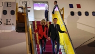 France's President Emmanuel Macron and his wife Brigitte Macron disembark from the plane upon their arrival at Noi Bai International Airport in Hanoi on May 25, 2025.  (Photo by Ludovic Marin / AFP)