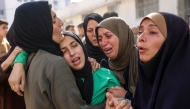 Women mourn relatives killed in an Israeli strike, at Al-Shifa hospital in Gaza City on May 26, 2025. (Photo by Omar Al-Qattaa / AFP)