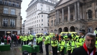 Police officers stand guard in front of the Liverpool Town Hall following an incident in Water Street (rear) on May 26, 2025. (Photo by Paul Ellis / AFP)
