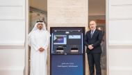 QNB officials pose for a photo with the Bulk Cash Deposit ATM machine.