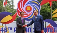 Malaysia's Prime Minister Anwar Ibrahim (R) greets Brunei's Sultan Hassanal Bolkiah before the plenary session at the 46th Association of Southeast Asian Nations (ASEAN) Summit in Kuala Lumpur on May 26, 2025. (Photo by MOHD RASFAN / POOL / AFP)
