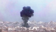 Smoke billowing above destroyed buildings during Israeli bombardment in the besieged Palestinian territory on May 27, 2025. (Photo by Jack Guez / AFP)