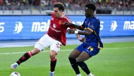 Manchester United's Manuel Ugarte (L) fights for the ball with Asean All-Stars Yaya Dukuly (R) the exhibition friendly football match between Manchester United and Asean All-Stars at the National Stadium Bukit Jalil in Kuala Lumpur on May 28, 2025. (Photo by Mohd RASFAN / AFP)