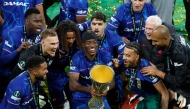 Chelsea's English midfielder #11 Noni Madueke holds the trophy after the UEFA Conference League final football match between Real Betis and Chelsea FC in Wroclaw on May 28, 2025. (Photo by Wojtek Radwanski / AFP)