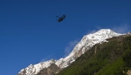 A Super Puma of Swiss air forces flies next to the Bietschhorn mountain above Wiler, on May 30, 2025, after the huge Birch Glacier collapsed. (Photo by Fabrice Coffrini / AFP)
 