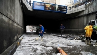 Municipal emergency service staff clear hail blocking an underpass after a windstorm struck Egypt's northern city of Alexandria on the Mediterranean coast in the early hours on May 31, 2025. (Photo by Hazem Gouda / AFP)
