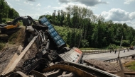 This handout photograph posted on the Telegram account of Kursk region acting governor Alexander Khinshtein (Telegram/@Hinshtein) on June 1, 2025 shows a damaged freight train at the site of a railway bridge collapse in the Kursk region. (Photo by Handout / Telegram/@Hinshtein / AFP)