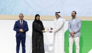 Minister of Communications and Information Technology, H E Mohammed bin Ali bin Mohammed Al Mannai presenting the award to Chief of Health Information and Communications Technology at HMC, Dr. Amal Abdulla.