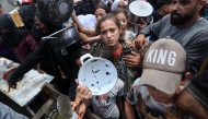  Palestinian children gather at a hot meal distribution point in Nuseirat in the central Gaza Strip, June 4, 2025. (Photo by Eyad BABA / AFP)