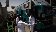 Muslim pilgrims disembark a bus in Mina near Islam's holy city of Mecca on June 3, 2025, ahead of the annual Hajj pilgrimage. (Photo by HAZEM BADER / AFP)
