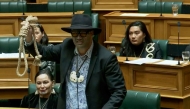 This screen grab taken from video released by the New Zealand Parliament on June 5, 2025 shows Maori Party co-leader Rawiri Waititi holding a noose while speaking at the parliament in Wellington. (Photo by Handout / New Zealand Parliament / AFP)