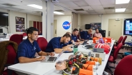 This handout photograph taken on September 12, 2024 and released by private aerospace company Axiom Space shows assigned and backup Ax-4 crew members (L to 2nd R) Shubhanshu Shukla, Tibor Kapu, Gyula Cserenyi (partly obscured), Slawosz Uznanski, and Prasanth Nair reviewing materials during emergency fire training at NASA's Johnson Space Center (JSC) in Houston, Texas. (Photo by AXIOM SPACE / AFP) 