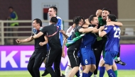 Uzbekistan's players celebrate after their 2026 FIFA World Cup Asian Qualifier football match against the United Arab Emirates ended in a draw, qualifying them for the World Cup for the first time, at Al-Nahyan Stadium in Abu Dhabi on June 5, 2025. (Photo by Fadel SENNA / AFP)
