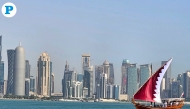 A dhow donning a Qatari flag sails smoothly on calm waters along the Corniche. (Photo by Marivie Alabanza / The Peninsula)

