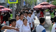 Students queue to enter a school during China's National College Entrance Examination (NCEE), known as “gaokao”, outside a high school in Beijing on June 7, 2025. (Photo by Adek Berry / AFP)