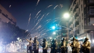 A firework explodes near police patrolling as protests continue in Los Angeles following three days of clashes with police after a series of immigration raids on June 09, 2025 in Los Angeles, California. Mario Tama/Getty Images/AFP 