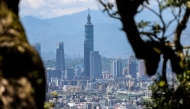 The Taipei 101 building stands among residential and commercial buildings in Taipei on June 10, 2025. (Photo by I-Hwa Cheng / AFP)