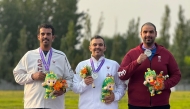 Qatar's Mohammed Al Rumaihi, Saeed Abu Shareb and Nasser Al Humaidi celebrate on the podium.