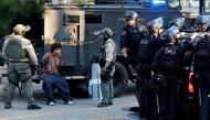 A detained person is treated for an injury as police detain protesters near City Hall as demonstrations continue after a series of immigration raids began last Friday on June 11, 2025 in Los Angeles, California. Mario Tama/Getty Images/AFP 