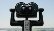 A pair of binoculars provided for visitors to watch the North Korean side of the Demilitarized Zone (DMZ) dividing the two Koreas, are seen at South Korea's Odusan Unification Observatory in Paju on June 12, 2025. (Photo by Anthony Wallace / AFP)
