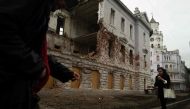 Pedestrians walk past a monument destroyed by Russian bombing in Sumy, north-eastern Ukraine, on June 12, 2025. (Photo by Florent Vergnes / AFP)
