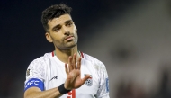Iran's forward #09 Mehdi Taremi greets the fans ater the 2026 FIFA World Cup Asian Qualifier football match between Qatar and Iran at Jassim Bin Hamad Stadium in Doha on June 5, 2025. (Photo by Karim JAAFAR / AFP)