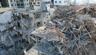 This aerial picture shows damaged buildings at a site hit by a missile fired from Iran in the Israeli city of Ramat Gan near Tel Aviv on June 14, 2025. (Photo by Jack GUEZ / AFP)
 