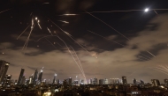 Israeli air defence systems are activated to intercept Iranian missiles over Tel Aviv on June 16, 2025. Photo by Menahem Kahana / AFP.