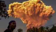 A villager watches the eruption of Mount Lewotobi Laki-Laki as seen from Talibura village in Sikka, East Nusa Tenggara, on June 17, 2025. (Photo by AFP)
 