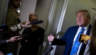 US President Donald Trump speaks to reporters about the G7 Summit aboard Air Force One while travelling back to Washington from Canada on June 16, 2025. (Photo by Brendan Smialowski / AFP)