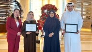 Katara Towers officials pose with some of the organisation's awards.