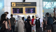 Passengers look at electronic boards displaying cancelled flights at the Ngurah Rai International Airport in Tuban near Denpasar on June 18, 2025. Sonny Tumbelaka /AFP. 