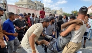Palestinians transport a man who was injured in Israeli fire while waiting near a food aid centre, into Khan Yunis' Nasser hospital in the southern Gaza Strip on June 17, 2025. Photo by AFP
