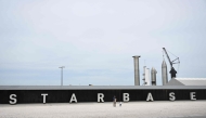 (Files) People take pictures of the rocket garden ahead of the SpaceX Starship flight test from Starbase in Boca Chica, Texas on April 16, 2023. (Photo by Patrick T. Fallon / AFP)