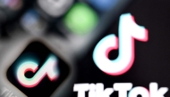 A photo taken on April 10, 2025 shows the Chinese social networking service TikTok's logos on a smartphone screen (L) and laptop screen in Frankfurt am Main, western Germany. Photo by Kirill KUDRYAVTSEV / AFP