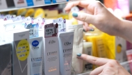 This photo taken on April 9, 2025 shows sunscreen products sunscreen products displayed on shelves at a major drug store in Tokyo's bustling Shibuya district. Photo by Kazuhiro NOGI / AFP