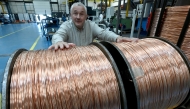 Photo used for representational purposes. Bruno Grandjean, President of Redex European engineering company, poses behind a reel of copper cable at Redex plant, in Ferrieres-en-Gatinais, central France, on June 18, 2025. Photo by JEAN-FRANCOIS MONIER / AFP.